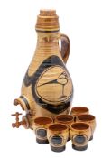 *A Paul Whalley earthenware cider set: comprising a tapering cistern with handle and tap painted