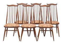 Ercol, a stained elm trestle dining table and six Goldsmith pattern dining chairs,