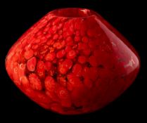 An art glass vase: of compressed globular form the clear body set with diced red and white canes,
