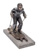 Leon Brunswick, an Art Deco patinated metal model of a female Alpine skier: on a naturalistic base,