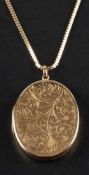 A 9ct gold oval locket pendant with engraved foliate decoration,: with hallmarks for Birmingham,