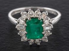 An emerald, round brilliant and baguette-cut diamond cluster ring,: estimated emerald weight ca. 1.