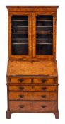 A George II burr walnut and feather banded bureau cabinet, second quarter 18th century,