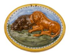 A large oval Pratt pearlware 'lion' plaque: moulded in relief with two reclining lions reclining on