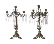 A pair of gilt metal four-branch candelabra with foliate decorated sconces,