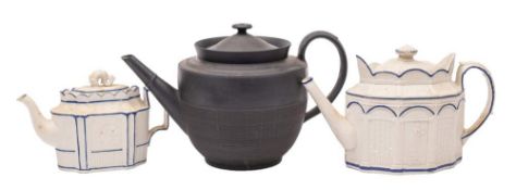 An early 19th century black basalt punch pot and cover and two Castleford-type teapots and covers: