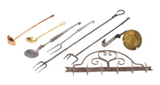 A wall hanging iron hanging rail with hooks: and seven various metal implements,