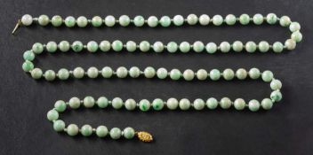 A jadeite bead necklace,: diameter of beads ca. 9.3-9.