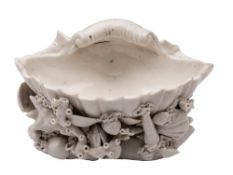 A Plymouth white shell salt: the single conch shell surrounded with small shells and seaweed,