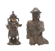 A Chinese bronze figure of a standing deity: in traditional costume on a domed base,
