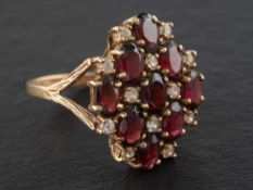 A 9ct gold, garnet and white paste cluster ring of chequerboard design,: with hallmarks for London,