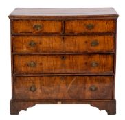 A George II walnut and crossbanded chest of drawers, circa 1735,