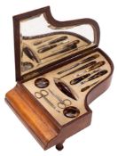 A 20th century leather musical vanity case in the form of a piano: containing faux tortoiseshell