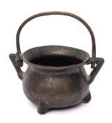 A 17th/18th Century bronze twin-handled apothecary or toy cauldron: with swing handle,