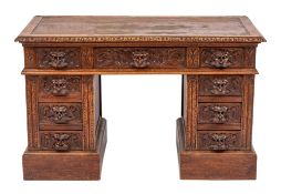 A Victorian carved oak pedestal desk in 17th century taste, late 19th century,