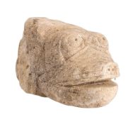 A carved stone corbel: in the form of a fish's head, with open mouth pierced nostrils and eyes, 21.
