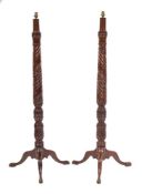 A pair of Victorian mahogany torchere stands refitted as standard lamps,