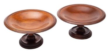 A pair of turned mahogany comports: each of circular outline with shallow dished top and moulded