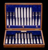 A set of twelve mother-of-pearl handled fruit knives and twelve forks: with steel blades and tines,