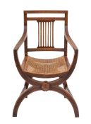 A Regency oak and caned elbow chair in the manner of a Savanarola chair, early 19th century,