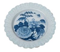 An English delftware dish: the cavetto painted in blue with peony, bamboo,