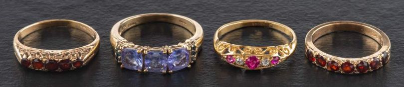 Four gemset half eternity rings,: including an 18ct gold ruby and diamond ring,