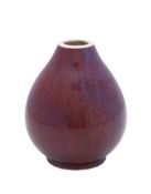 A Chinese sang de bouef glazed Chinese porcelain vase: of oviform under lavender tinted flambé