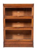 An Edwardian oak and glazed three section bookcase by Globe Wernicke, early 20th century,