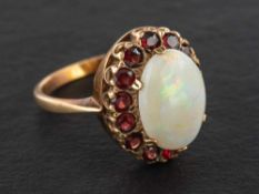 A 9ct gold cabochon-cut opal and garnet cluster ring,: estimated opal weight ca. 2.