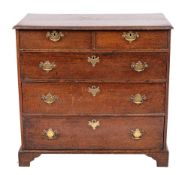 A late George II or George III oak chest of drawers, circa 1760,: the top with moulded edges,