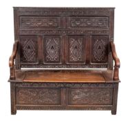 A Victorian carved oak settle, last quarter 19th century,