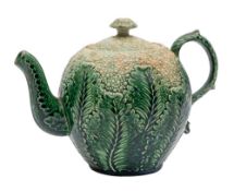 A Staffordshire creamware 'cauliflower' teapot and cover: with foliate scroll handle,