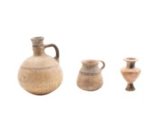 A Mycenaean pottery vessel: of ovoid form with loop handle and banded amber decoration, 17cm high,