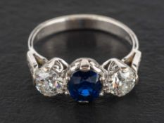 An 18ct gold, sapphire and round, brilliant-cut diamond, three-stone ring,