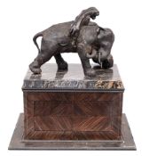 A 20th century bronzed metal study of an elephant attacked by two lions: one lion under the