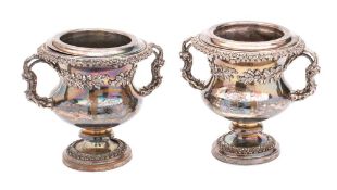 A pair of late 19th century silver plated wine coolers: of campagna form with cast oak leaf and
