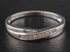 An 18ct gold, round, brilliant-cut diamond cross-over ring,: total diamond weight 0.