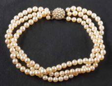 A cultured pearl three-string choker necklace,: to a circular, pearl-set clasp, stamped '9ct',