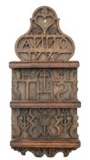 A carved wood spoon rack: of arched outline, dated 199? with fret cut cross and initials,