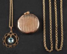 Two early 20th century pendants,: including a circular locket pendant with engine-turned decoration,