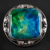 Attributed to Artificers' Guild, a circular blue and green enamel brooch,