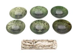 A set of six green jadeite finger bowls: of plain circular form, with mottled inclusions,