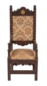 A late 19th century oak Master's chair in the 17th century style: the foliate craved toprail with