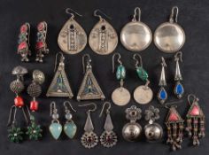 A collection of Indian drop earrings,: some set with vari-coloured paste and gemstones,
