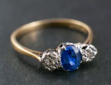 A sapphire and old-cut diamond ring, three-stone ring,: total estimated diamond weight ca. 0.