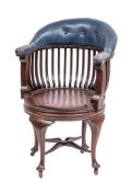 A Victorian mahogany and blue leather upholstered revolving desk chair, late 19th century,