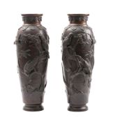 A pair of Japanese bronze vases: decorated in low relief with birds amongst blossoming shrubs,