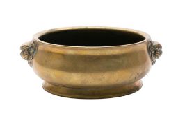 A Chinese bronze censer: of squat circular form with stylized dragon mask decorated handles to the
