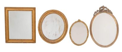 Three gilt composition framed oval wall mirrors, late 19th century,: of varying size and design,