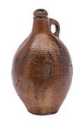 A German brown saltglaze stoneware Bellarmine jug: with loop handle, late 17th/18th century,